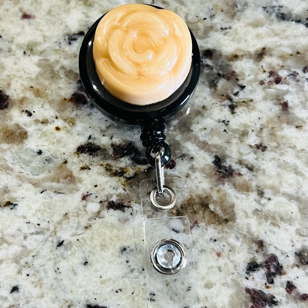 Tan flower diamond badge reel.